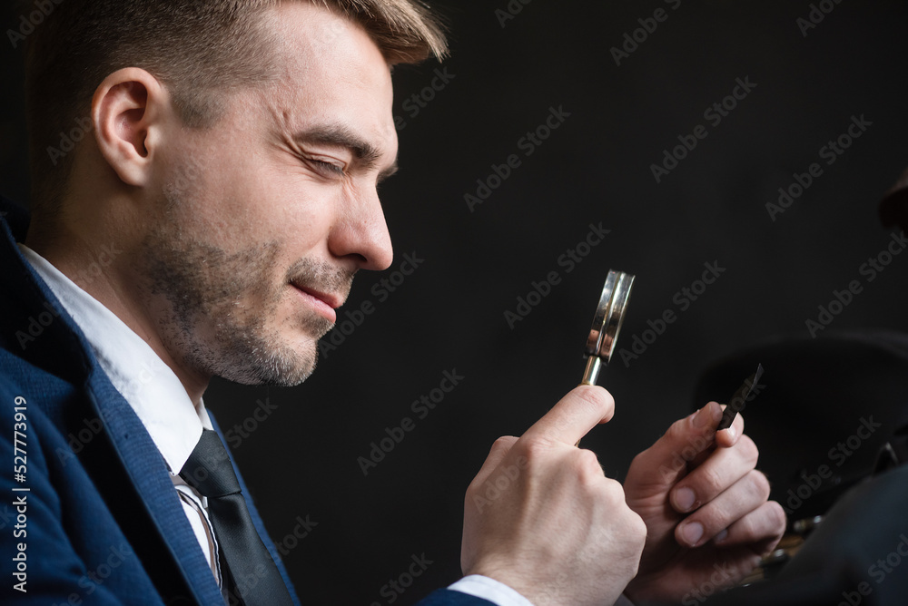 Retro style detective agent is looking for evidences through the magnifying glass concept.