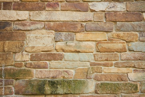 Background texture of a stone wall photo. Natural stone wall texture for the background. Old brick texture, grunge background of a brick wall.