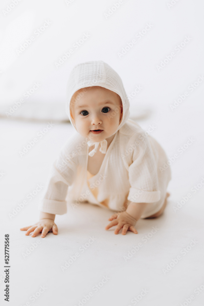 Cute studio portrait of a little newborn which has already begun to crawl. The child laughs and rejoices in his first little steps Cute studio portrait of a little newborn which has already begun to crawl. The child laughs and rejoices in his first little steps