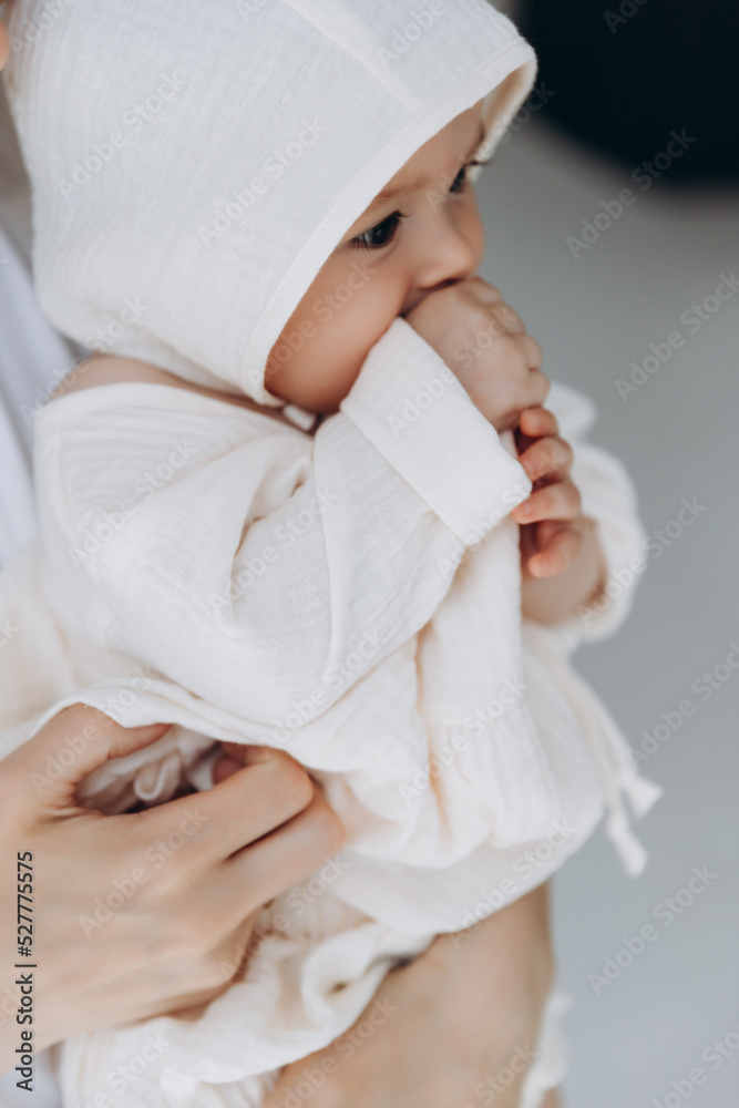 Loving mother carying of her newborn baby at home. Bright portrait of happy mum holding cute infant child on hands. Mother hugging her little 3 months old daughter. Loving mother carying of her newborn baby at home. Bright portrait of happy mum holding cute infant child on hands. Mother hugging her little 3 months old daughter.