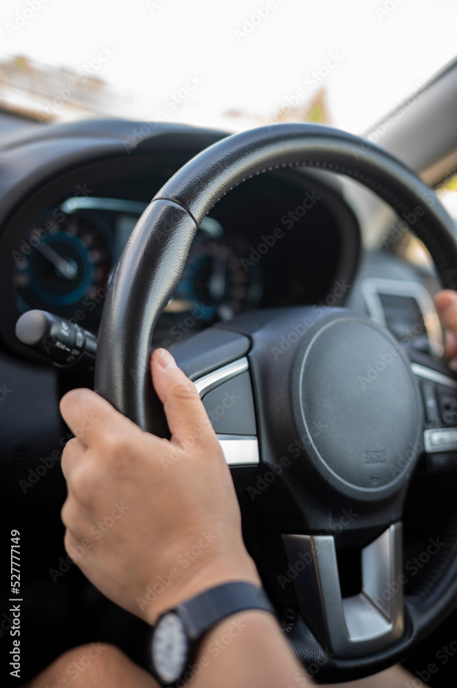 自動車を運転している男性の手