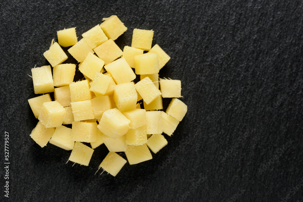 top view of diced fresh vegetables roots of ginger on black slate stone background top view of diced fresh vegetables roots of ginger on black slate stone background