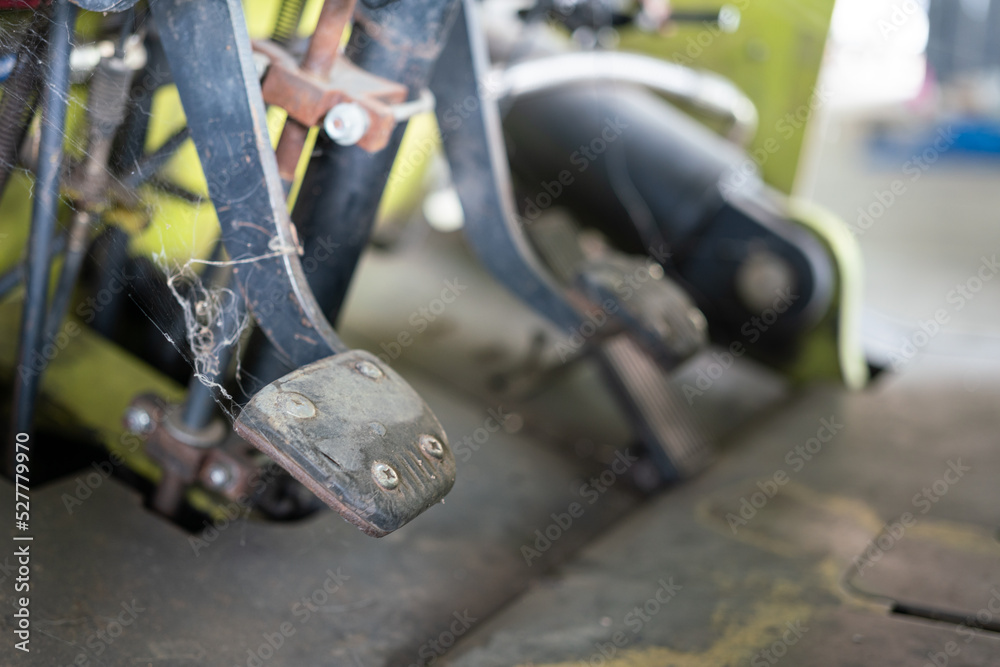 Close-up at step gas pedal or throttle step of a factory forklift vehicle. Industrial vehicle object part photo. Selective focus. Close-up at step gas pedal or throttle step of a factory forklift vehicle. Industrial vehicle object part photo. Selective focus.