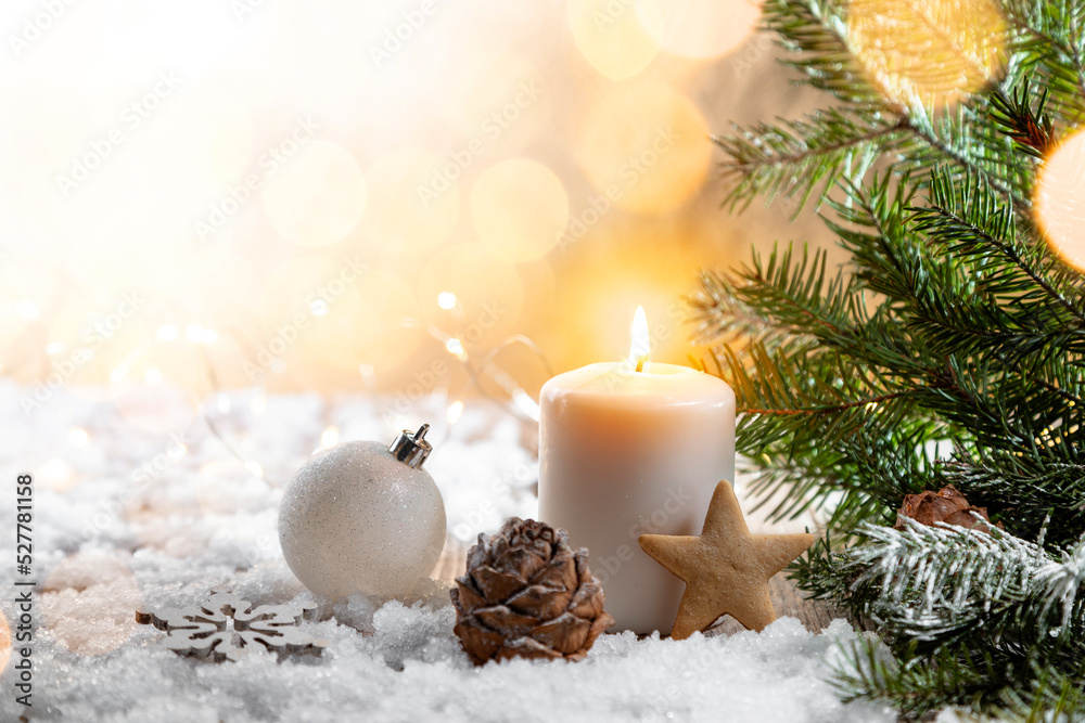 Christmas candle on snow-covered boards - decoration with natural elements, twigs, pine cones, Christmas decorations.