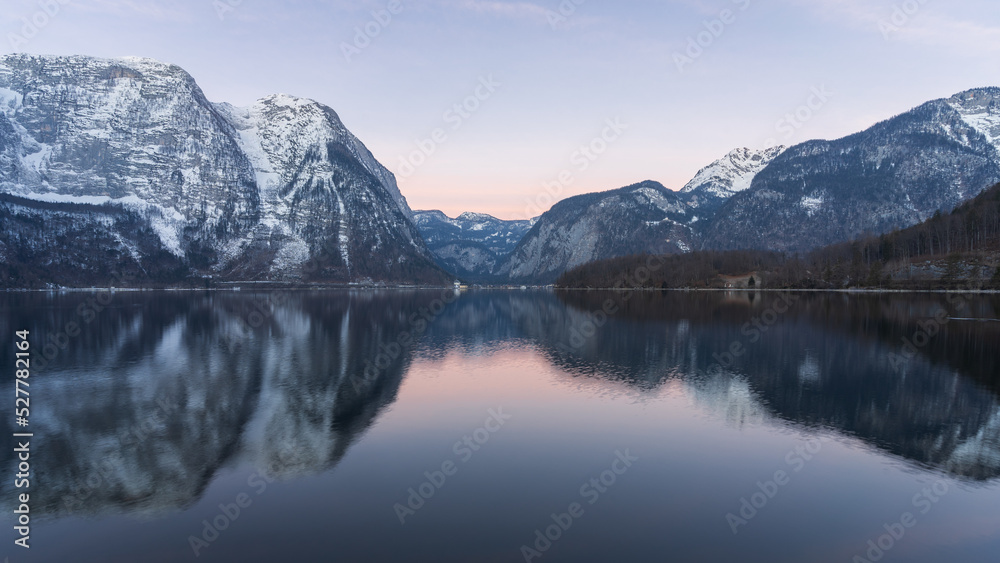 Beautiful alpine lake reflecting surrounding peaks during sunrise, wide shot, Austria, Europe