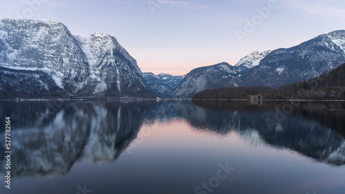 Beautiful alpine lake reflecting surrounding peaks during sunrise  wide shot  Austria  Europe