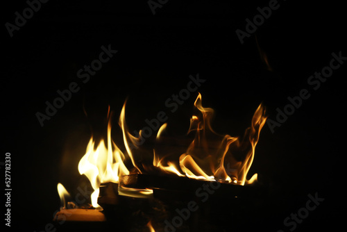 The flames of burning wood in the fireplace of a country house. Coals and sparks.