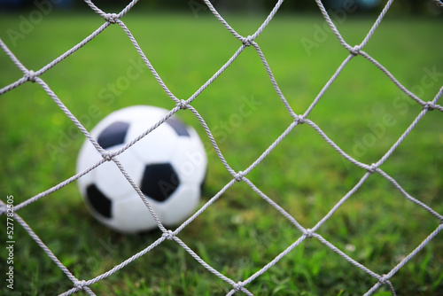 The child goes in for sports at the stadium. The boy is training before playing football.