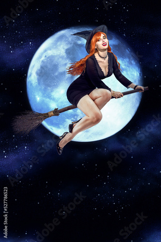 Halloween Witch flying on a broomstick. Female wizard fairy character for All Saints' Day. Fantasy gothic red-haired sorceress girl dressed in black carnival costume © TSViPhoto