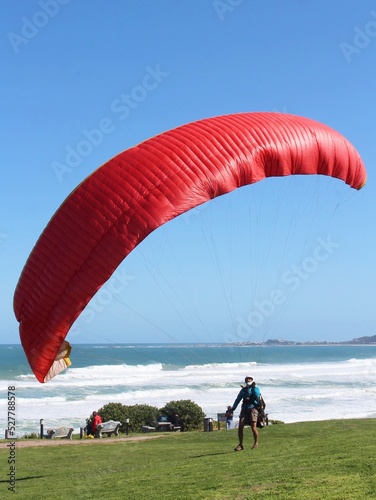 Paraglider landing at a seaside