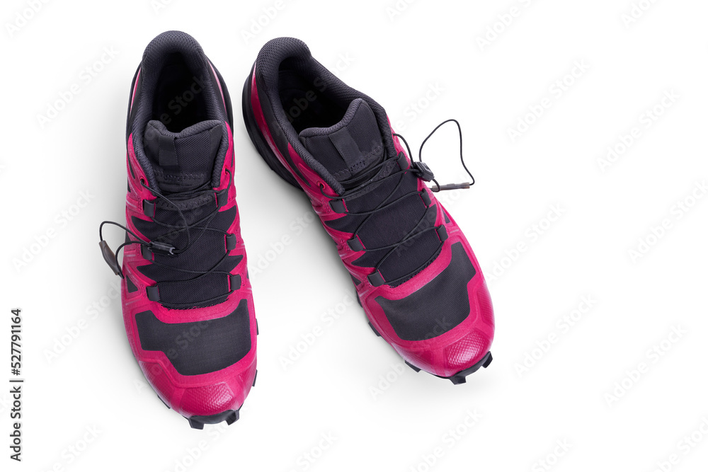 A side view of pink, magenta and black trainers, sneakers Isolated on a flat background.