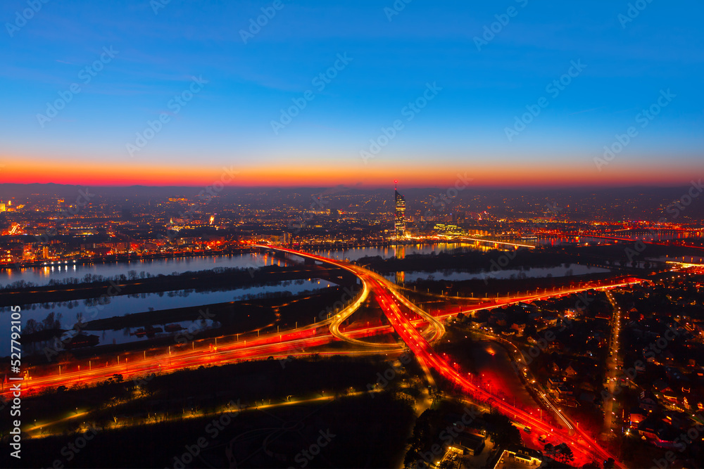 Fototapeta premium Vienna evening panorama . Illuminated Vienna city and Danube river . Urban infrastructure aerial night view 