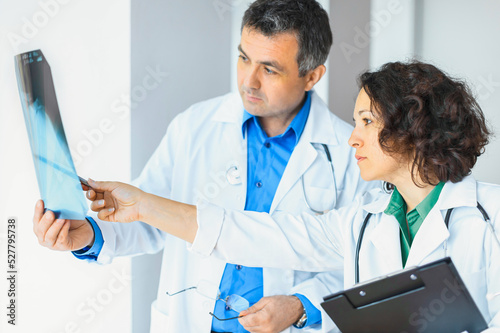 Female and male doctor discussing x-rays