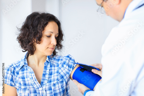 Doctor takes blood pressure on patient