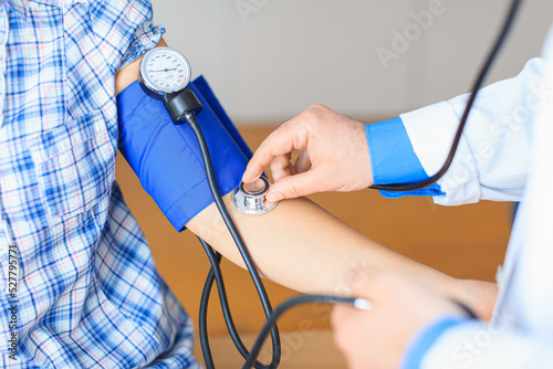 Doctor examines patient with stethoscope close up