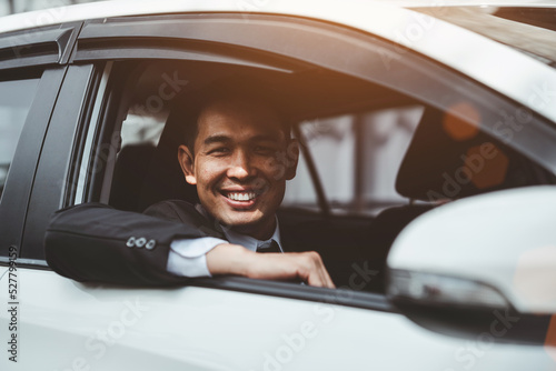 Happy young Asian businessman driving a car. © makibestphoto
