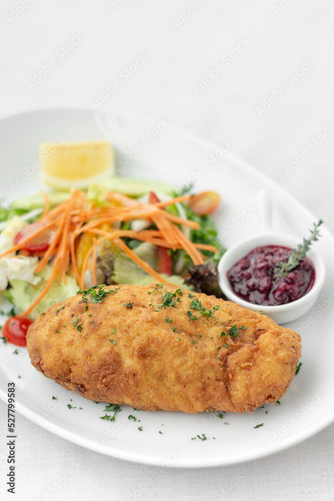 chicken cordon bleu with salad and cranberry sauce chicken cordon bleu with salad and cranberry sauce