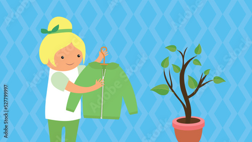 girl holding a hanger with a jacket near a flower