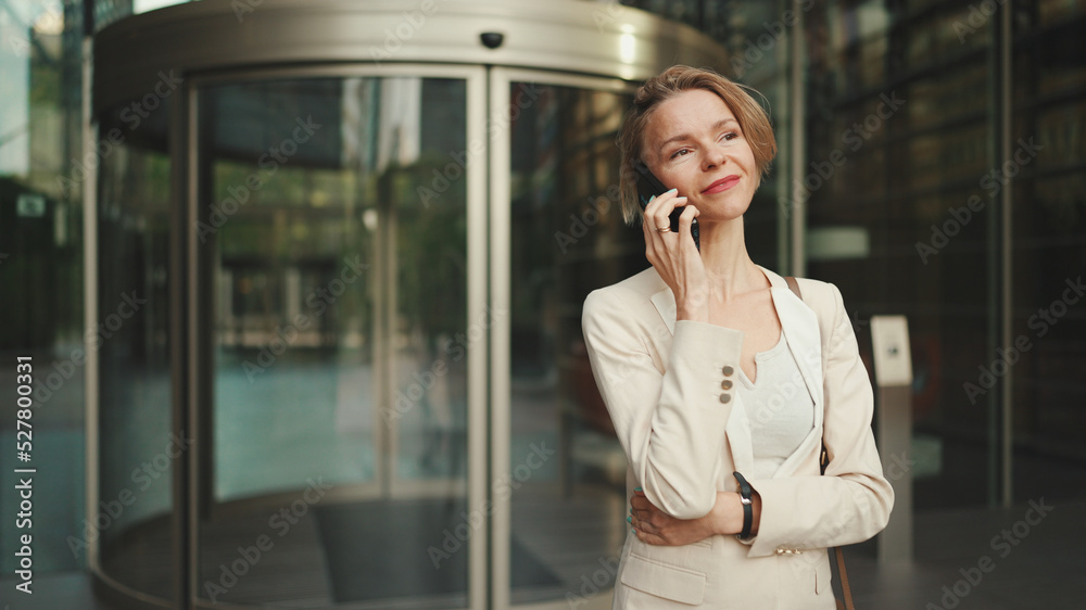 Close up, businesswoman talking on the cellphone on business center background