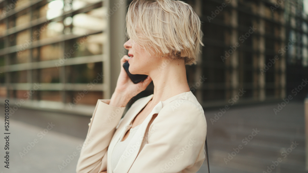 Fototapeta premium Close up, businesswoman talking on the cellphone on business center background