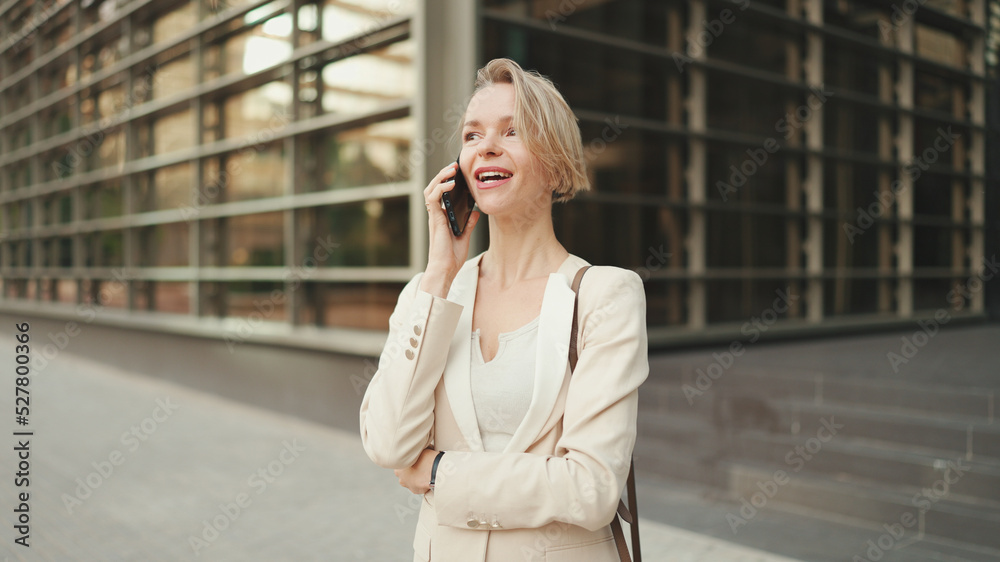 Close up, businesswoman talking on the cellphone on business center background