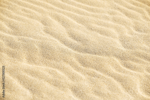 Sand on the beach as a background. Close-up sand texture. Summer sunlight. Top view. © ita_tinta_