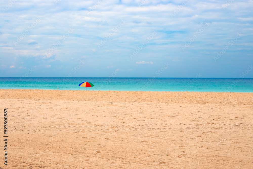 Sea beach and sandy shore with sun umbrella. Rest and relaxation on holiday at the resort