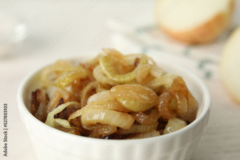 Tasty fried onion in bowl on light background, closeup Tasty fried onion in bowl on light background, closeup