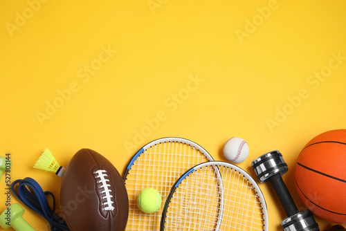 Set of different sports equipment on yellow background, flat lay. Space for text © New Africa