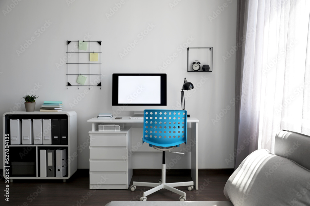 Comfortable blue chair near desk in stylish office interior