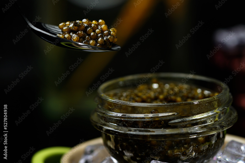Black caviar on a black background, a beautiful background. Russian cuisine.