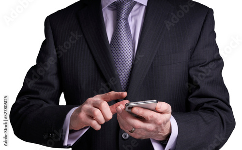 A cutout of a businessman holding and operating a touch screen phone. A design element for use with composite image creation.