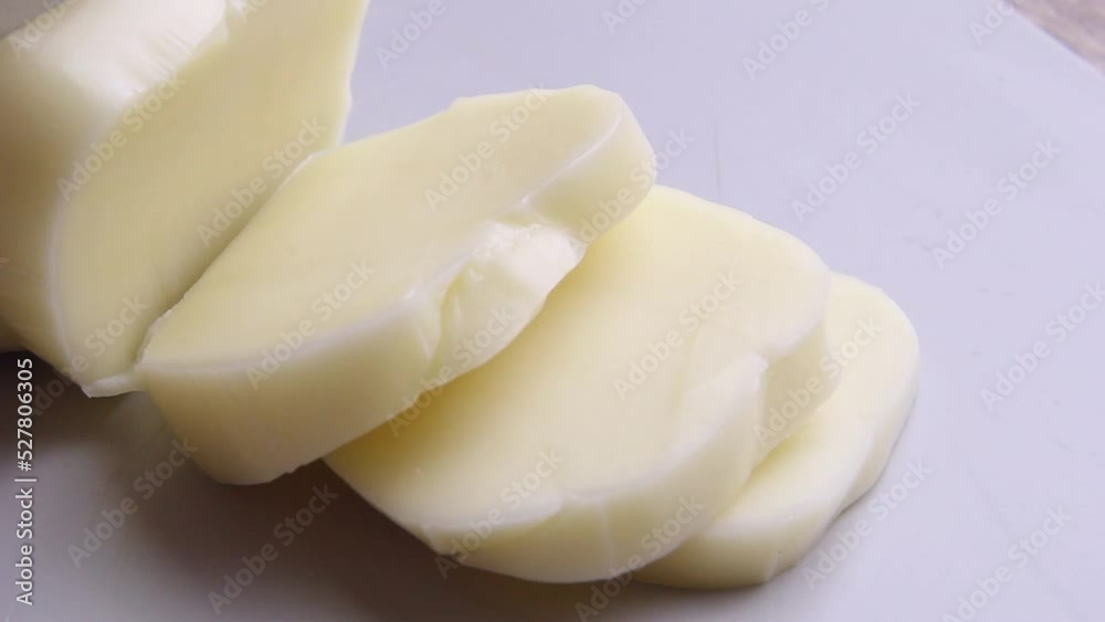 Mozzarella cheese close-up cut into pieces. Mozzarella cheese close-up cut into pieces.