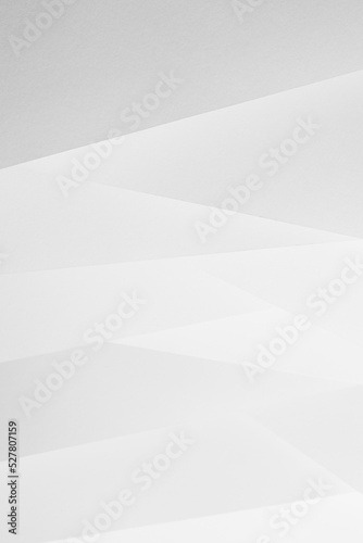 White abstract geometric background with soft light paper inclined vertical lines or surfaces with gradient as pattern, vertical. Simple elegant modern backdrop in minimal style.