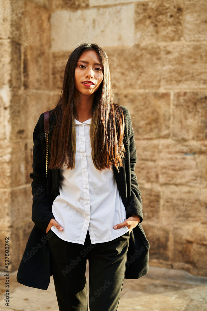 Stylish Hispanic woman near shabby building Stylish Hispanic woman near shabby building