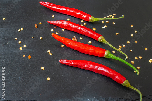 Cayenne pepper,Fresh chili on black table.Assortment of fresh and dryed peppers cayenne.