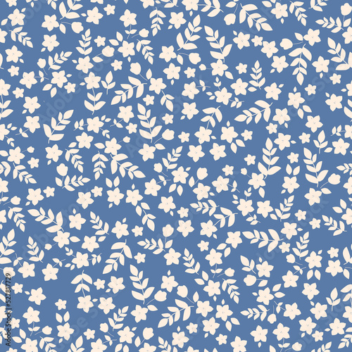 Simple vintage pattern. small white flowers and leaves. blue background. Fashionable print for textiles and wallpaper.