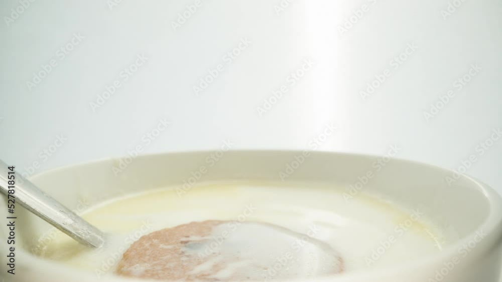 I throw cookies with chocolate pieces into a mug with milk, splashes. Close-up. slow motion. I throw cookies with chocolate pieces into a mug with milk, splashes. Close-up. slow motion.