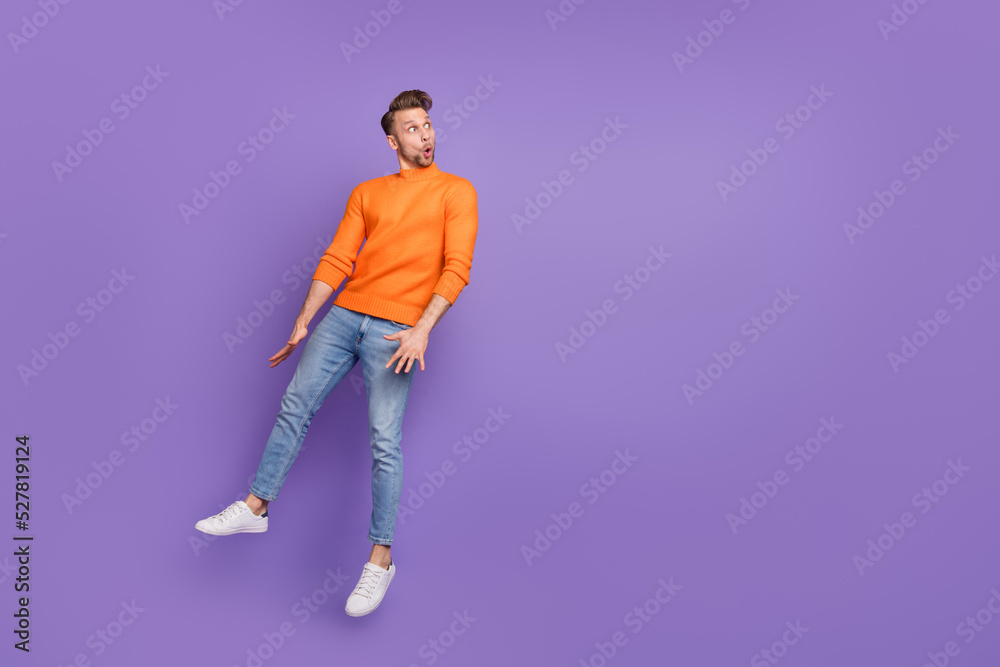 Full body photo of impressed funny man look blank space see big sale discount promo isolated on violet color background Full body photo of impressed funny man look blank space see big sale discount promo isolated on violet color background