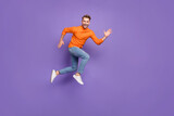 Full size photo of good mood delighted man running summer vacation have fun isolated on purple color background