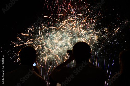 Photography Black silhouette of people on the background of fireworks