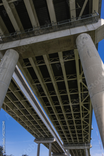 View Underneath a Large Bridge Highway on a Sunny Day with Blue Sky
