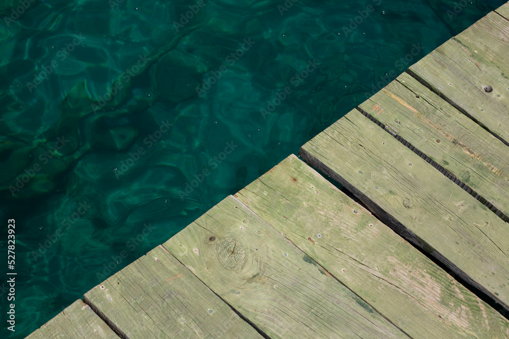 wooden pier on a background of turquoise water