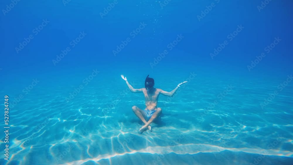 Boy does concentration exercises underwater in the ocean Boy does concentration exercises underwater in the ocean