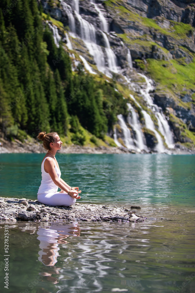 A woman practices yoga in the mountains A woman practices yoga in the mountains