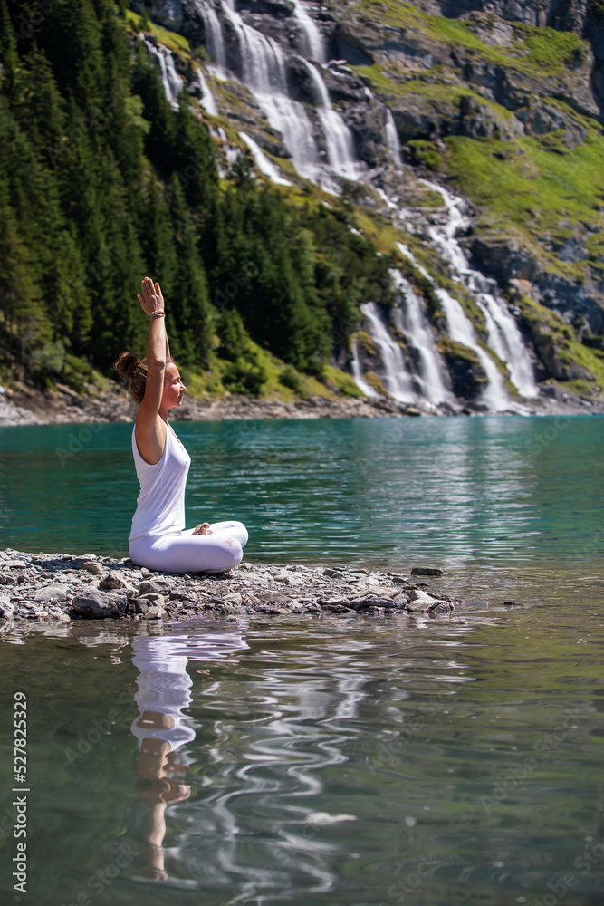 A woman practices yoga in the mountains A woman practices yoga in the mountains