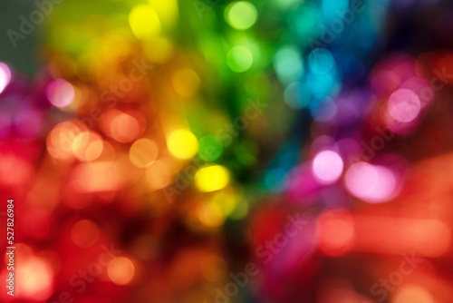 Blurred bokeh background for Christmas and New Year holiday. Abstract colorful wallpaper with defocused lights. Copy space