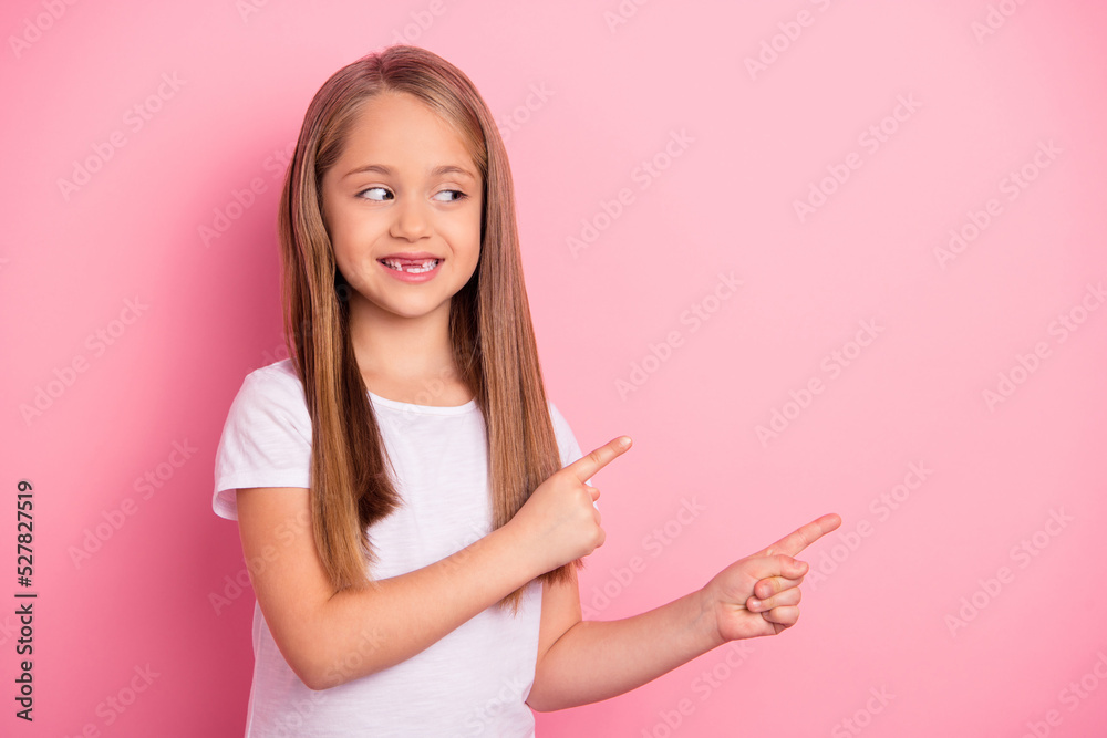 Portrait of positive cheerful person look indicate fingers empty space blank isolated on pink color background Portrait of positive cheerful person look indicate fingers empty space blank isolated on pink color background
