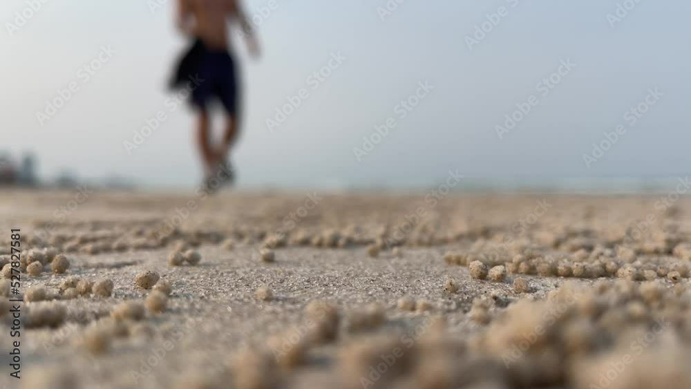 Blurred shirtless man walking on beach on sunny day. Landscape nature view with light blue sky Blurred shirtless man walking on beach on sunny day. Landscape nature view with light blue sky