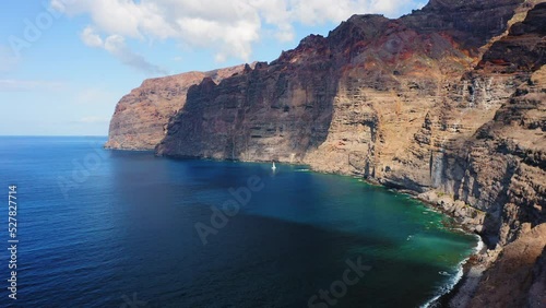 Wallpaper Mural Lonely yacht sailing at sunlight. Aerial. White sailboat on serene seascape at open sea. Boat moored in ocean bay. Deep azure water on summer sunny day. Cinematic drone footage. Tenerife island. Torontodigital.ca
